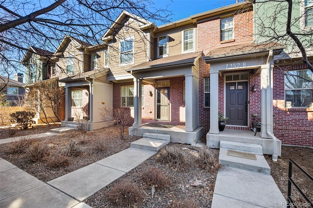 townhome / multi-family property with brick siding