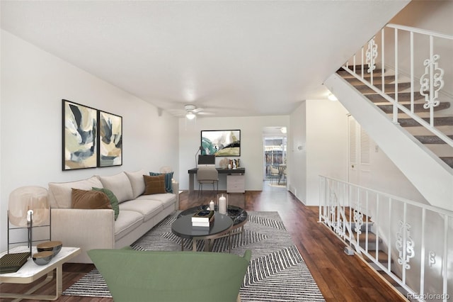 living room featuring dark hardwood / wood-style flooring and ceiling fan