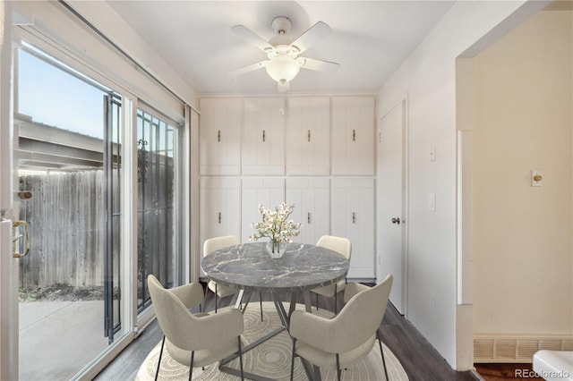 dining room with ceiling fan and dark hardwood / wood-style flooring