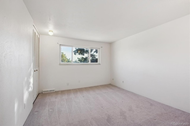 empty room with light colored carpet