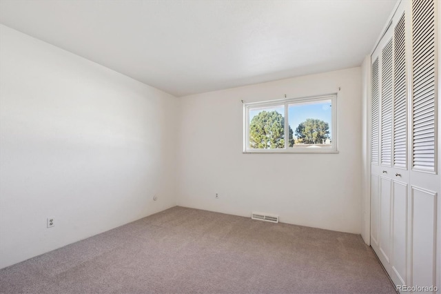 unfurnished bedroom with carpet floors and a closet