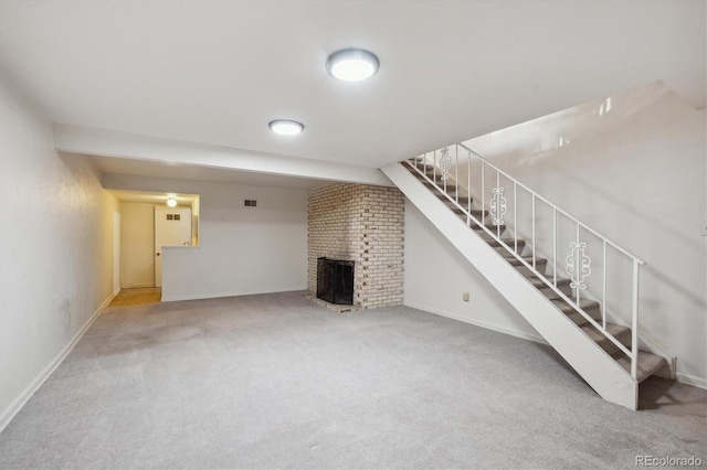 unfurnished living room with light colored carpet and a fireplace