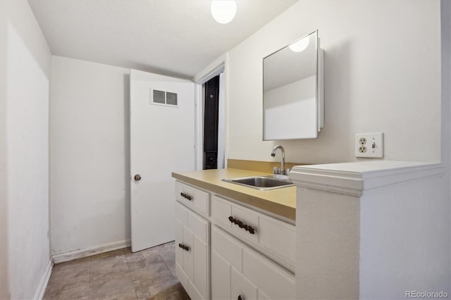 bathroom featuring vanity and vaulted ceiling