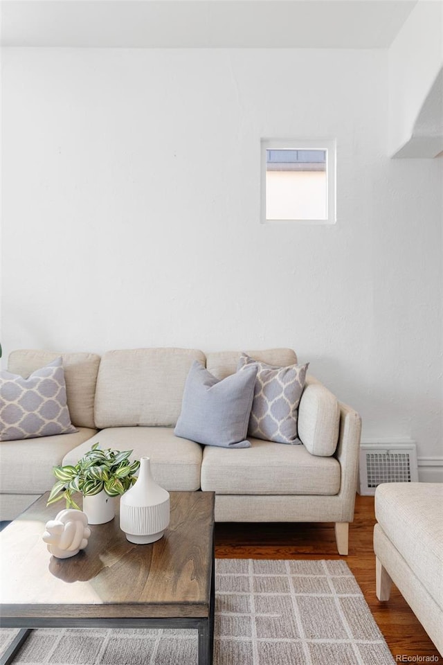 living room featuring wood finished floors and visible vents