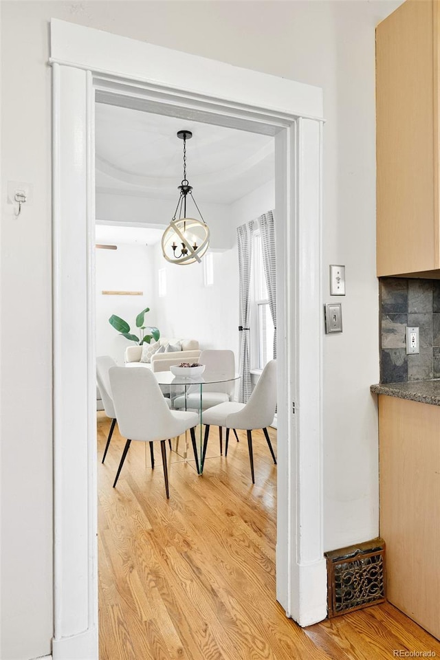 dining room featuring a notable chandelier and light wood-style floors