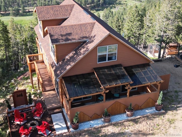 72 Hilltop Dr, Bailey, CO 80421 - view of front of house with a shingled roof, a view of trees, stairway, and a wooden deck