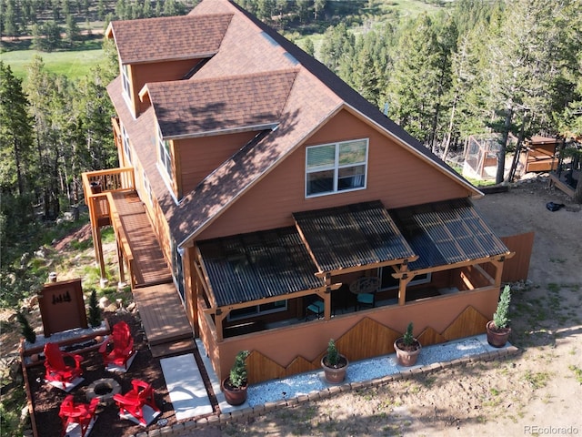 72 Hilltop Dr, Bailey, CO 80421 - view of front of home featuring a shingled roof, a view of trees, stairway, and a deck