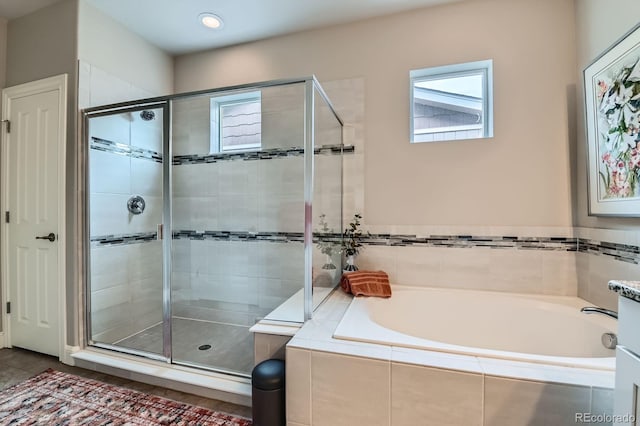 full bath featuring a stall shower and a garden tub