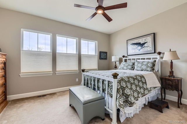 carpeted bedroom featuring visible vents, baseboards, and a ceiling fan