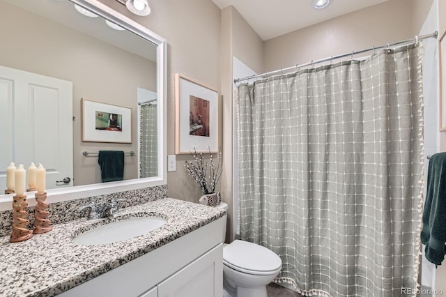 full bathroom with vanity and toilet