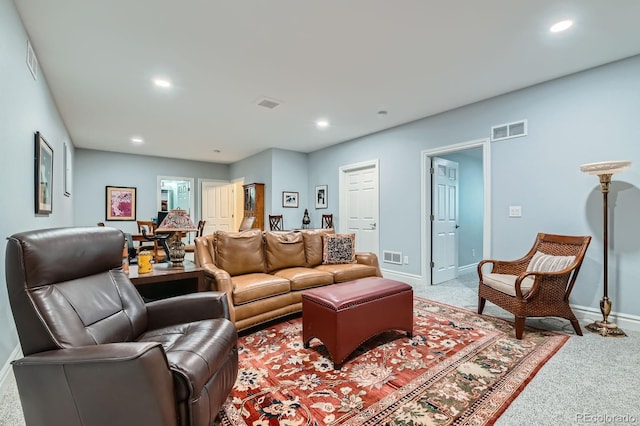 carpeted living room with recessed lighting, visible vents, and baseboards