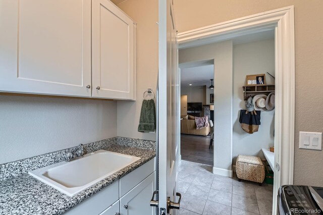 bathroom featuring vanity, baseboards, and tile patterned floors