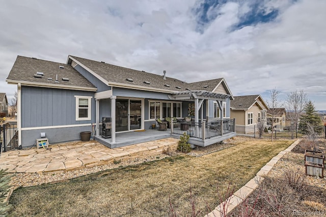 rear view of house with a patio, fence, a deck, a yard, and a pergola