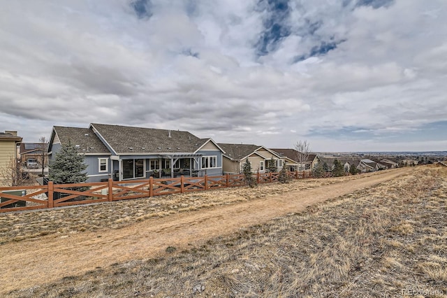 view of front of home featuring fence