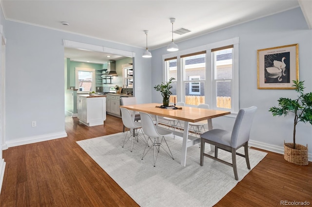 3332 N Vine St, Denver, CO 80205 - dining space with dark wood-style floors, baseboards, and ornamental molding