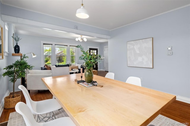 3332 N Vine St, Denver, CO 80205 - dining area featuring wood finished floors, baseboards, a chandelier, and ornamental molding