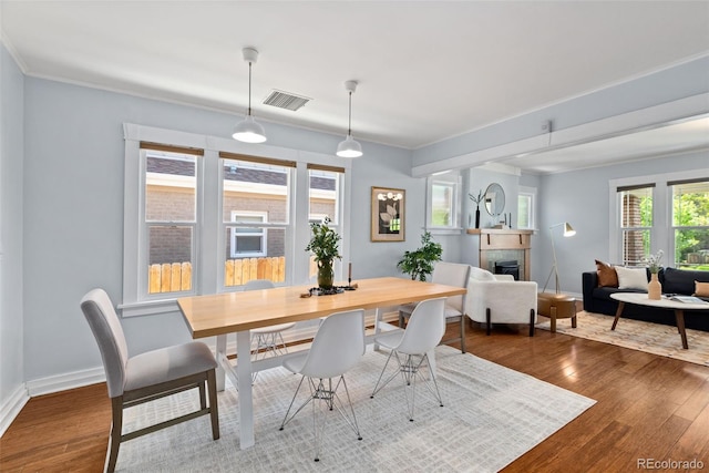 3332 N Vine St, Denver, CO 80205 - dining area featuring dark wood-style floors, a fireplace, and baseboards