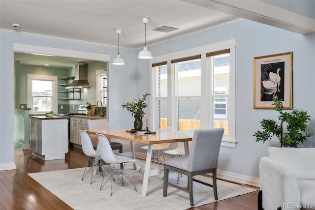 3332 N Vine St, Denver, CO 80205 - dining room with dark wood finished floors, plenty of natural light, ornamental molding, and baseboards