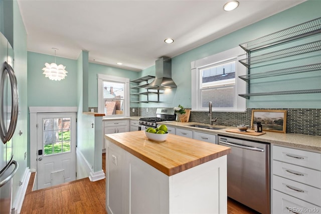 3332 N Vine St, Denver, CO 80205 - kitchen with appliances with stainless steel finishes, a sink, wall chimney exhaust hood, wooden counters, and open shelves