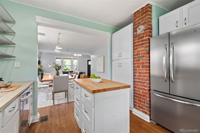 3332 N Vine St, Denver, CO 80205 - kitchen with appliances with stainless steel finishes, wood counters, dark wood-type flooring, ornamental molding, and white cabinets