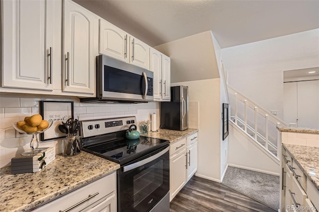 kitchen with appliances with stainless steel finishes, dark wood-style flooring, and white cabinets
