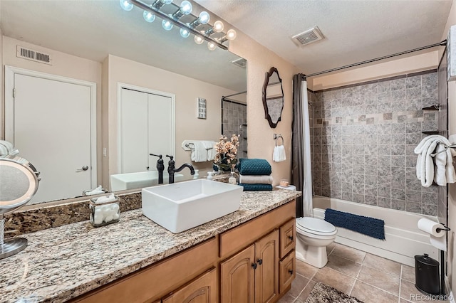 bathroom with shower / tub combo with curtain, tile patterned floors, toilet, and vanity