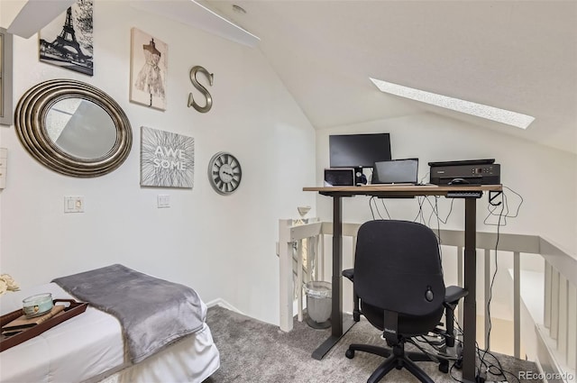 bedroom with a skylight, vaulted ceiling, a desk, and carpet