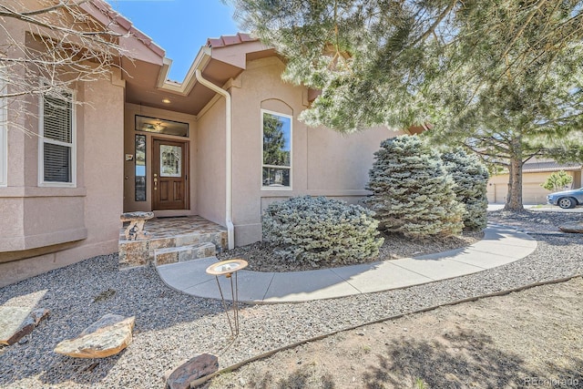 property entrance with stucco siding