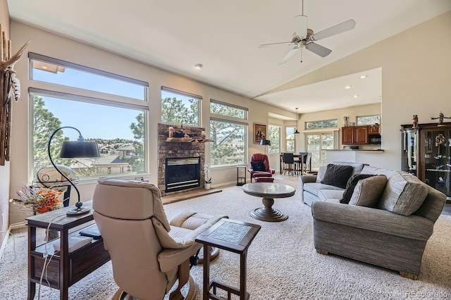 living area featuring vaulted ceiling, ceiling fan, a fireplace, baseboards, and carpet flooring