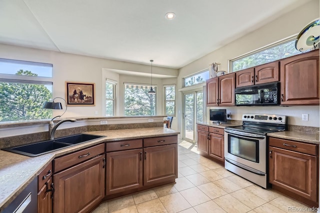 kitchen featuring electric range, black microwave, a sink, and plenty of natural light