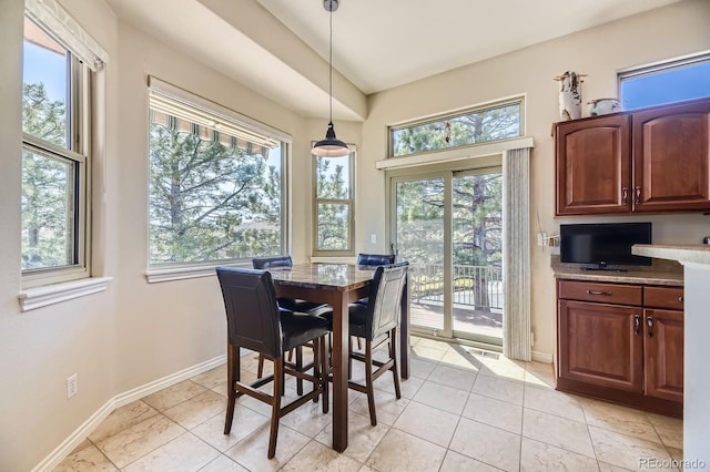dining area featuring baseboards and light tile patterned flooring