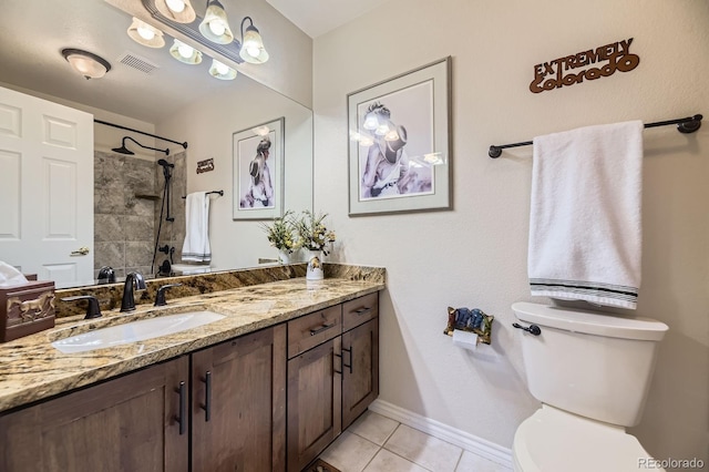 full bath featuring tile patterned floors, vanity, a tile shower, toilet, and visible vents