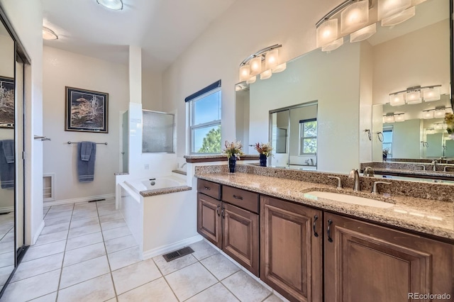 full bath with a garden tub, tile patterned flooring, vanity, and visible vents