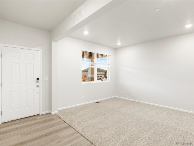 foyer entrance with light hardwood / wood-style floors