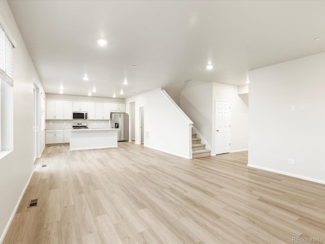 unfurnished living room with light hardwood / wood-style floors