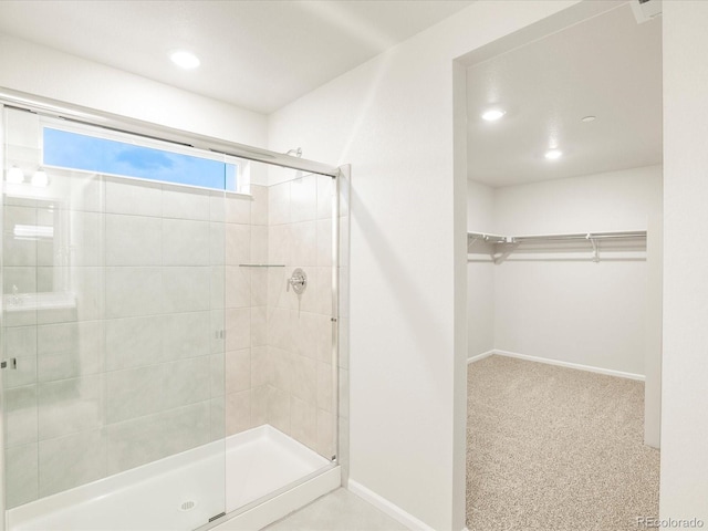 bathroom featuring a shower with shower door