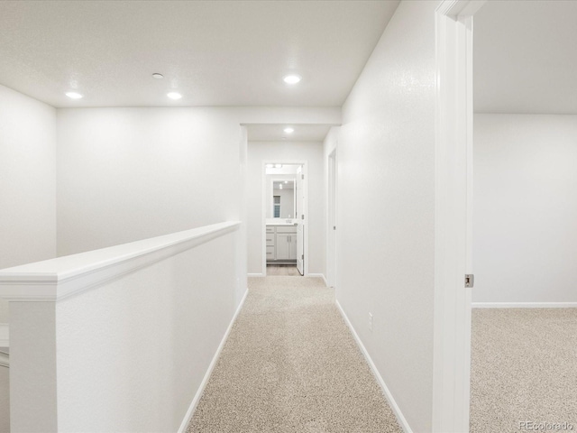 hall featuring light colored carpet