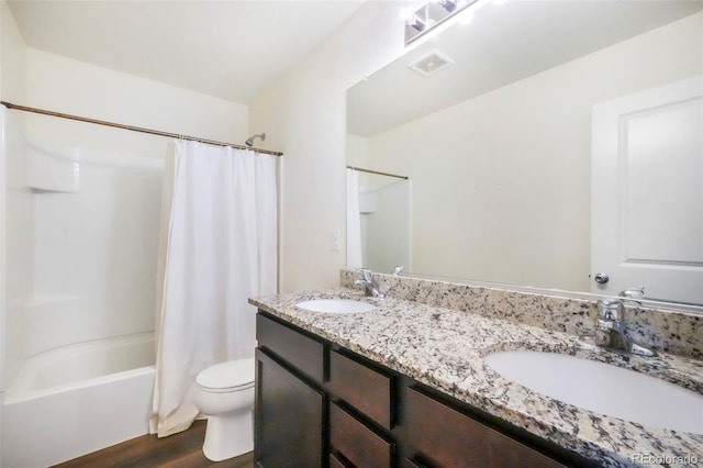 47312 Lilac Ave, Bennett, CO 80102 - bathroom with toilet, double vanity, wood finished floors, and shower / bath combo with shower curtain