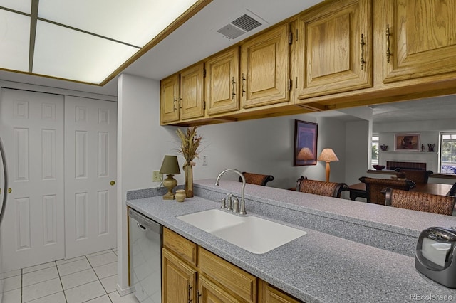 7000 E Quincy Ave Unit 302, Denver, CO 80237 - kitchen with dishwasher, a sink, light tile patterned floors, a fireplace, and light countertops