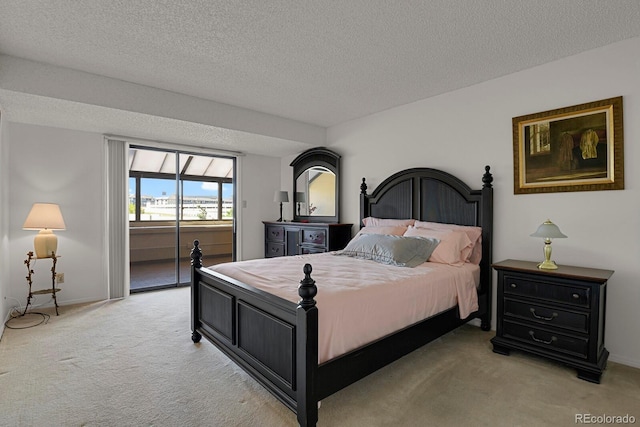 7000 E Quincy Ave Unit 302, Denver, CO 80237 - bedroom with light carpet, a textured ceiling, access to exterior, and baseboards