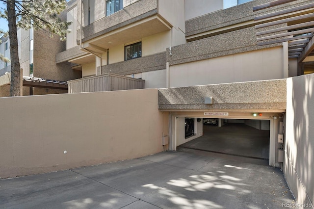 7000 E Quincy Ave Unit 302, Denver, CO 80237 - view of building exterior featuring concrete driveway and an attached garage