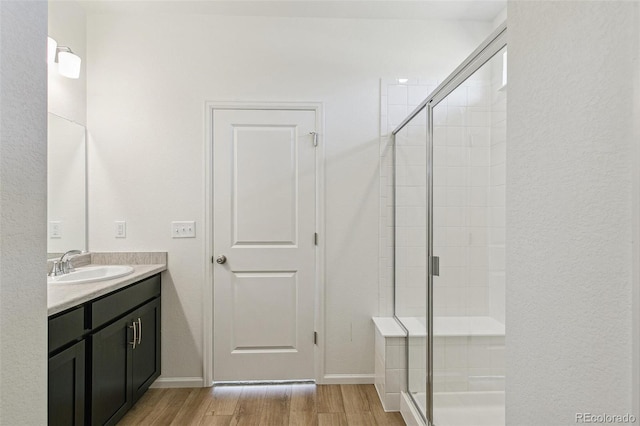 9332 Bahama Ct, Commerce City, CO 80022 - bathroom with vanity, baseboards, a shower stall, and wood finished floors