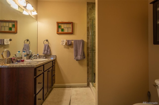 10473 Table Rock Ct Unit E, Poncha Springs, CO 81242 - full bath with double vanity, an enclosed shower, baseboards, toilet, and tile patterned floors
