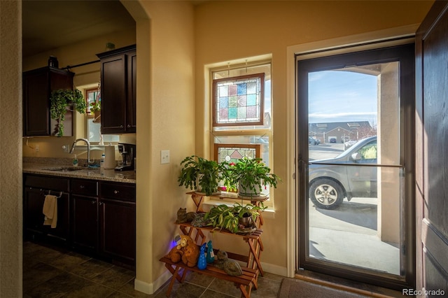 10473 Table Rock Ct Unit E, Poncha Springs, CO 81242 - doorway featuring a sink, baseboards, and dark tile patterned flooring