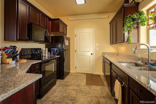 10473 Table Rock Ct Unit E, Poncha Springs, CO 81242 - kitchen featuring black appliances, a sink, baseboards, light stone counters, and dark brown cabinetry