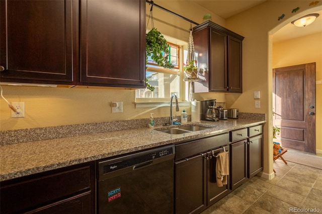 10473 Table Rock Ct Unit E, Poncha Springs, CO 81242 - kitchen featuring dishwashing machine, a sink, dark brown cabinetry, arched walkways, and light stone countertops