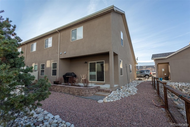 10473 Table Rock Ct Unit E, Poncha Springs, CO 81242 - back of house featuring stucco siding