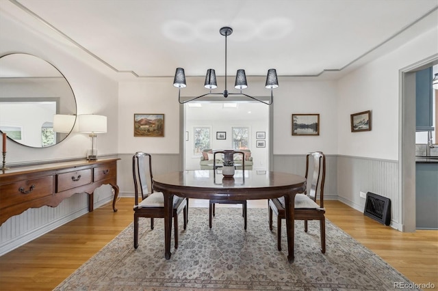 629 Bellaire St, Denver, CO 80220 - dining area featuring light wood-style floors and wainscoting