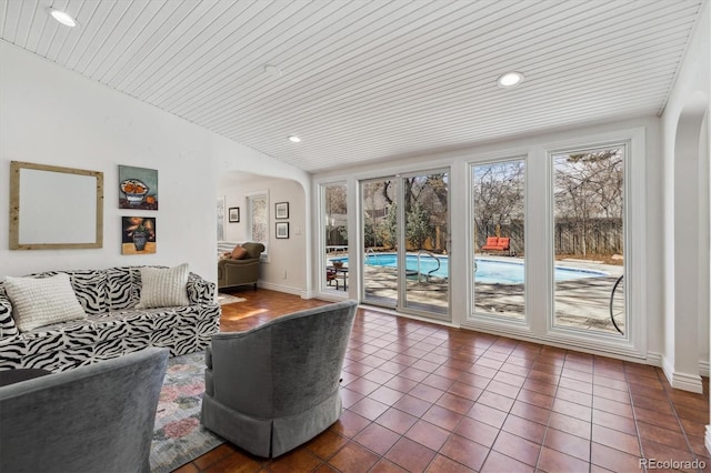 629 Bellaire St, Denver, CO 80220 - living area with arched walkways, vaulted ceiling, dark tile patterned flooring, recessed lighting, and wooden ceiling