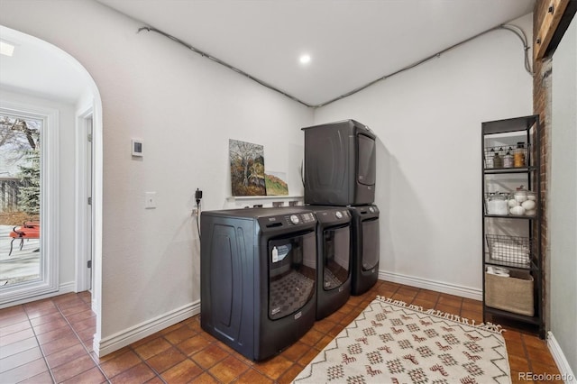 629 Bellaire St, Denver, CO 80220 - laundry room with arched walkways, tile patterned floors, and baseboards